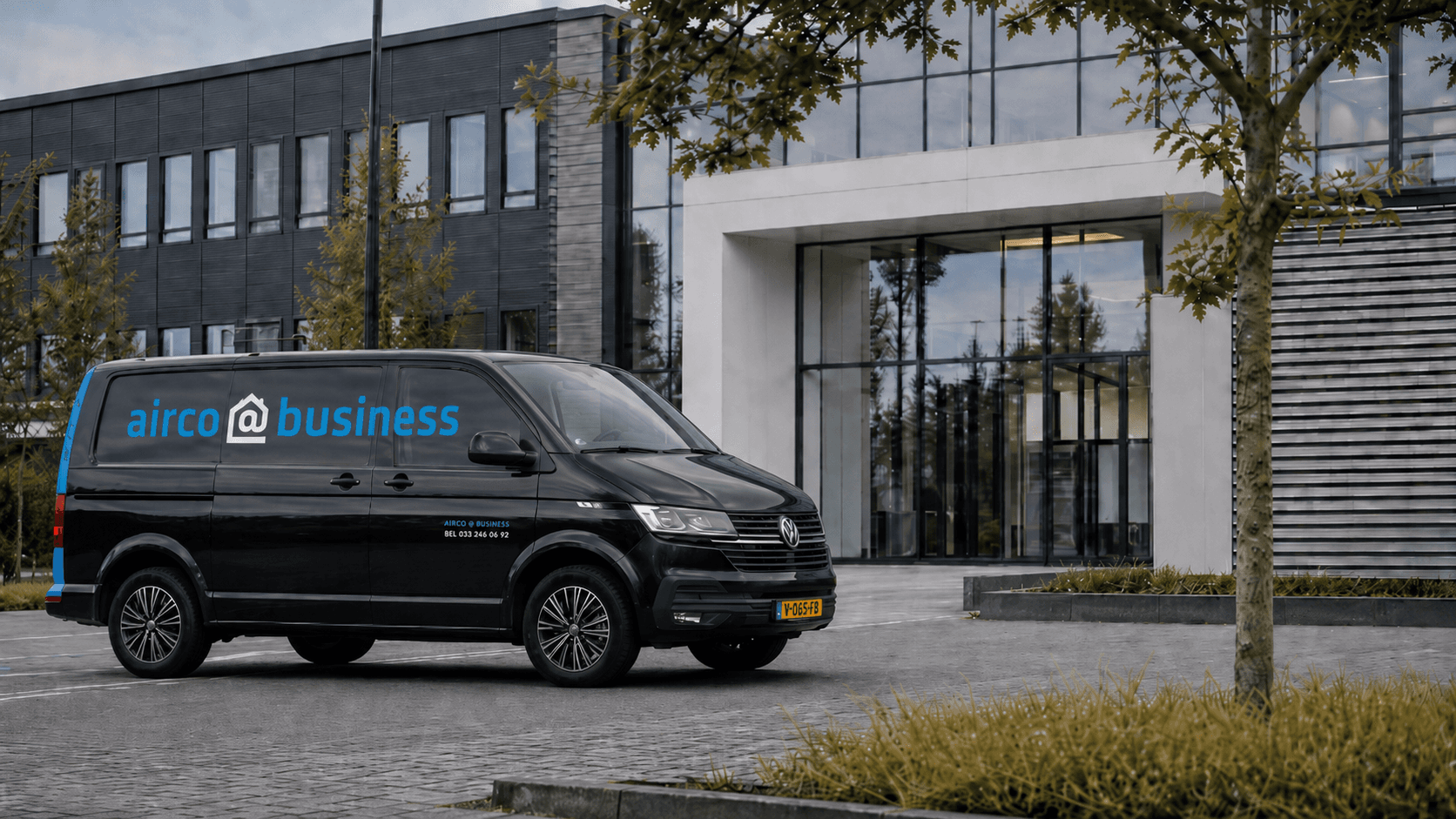 Service van arriving at a commercial property for air conditioning maintenance