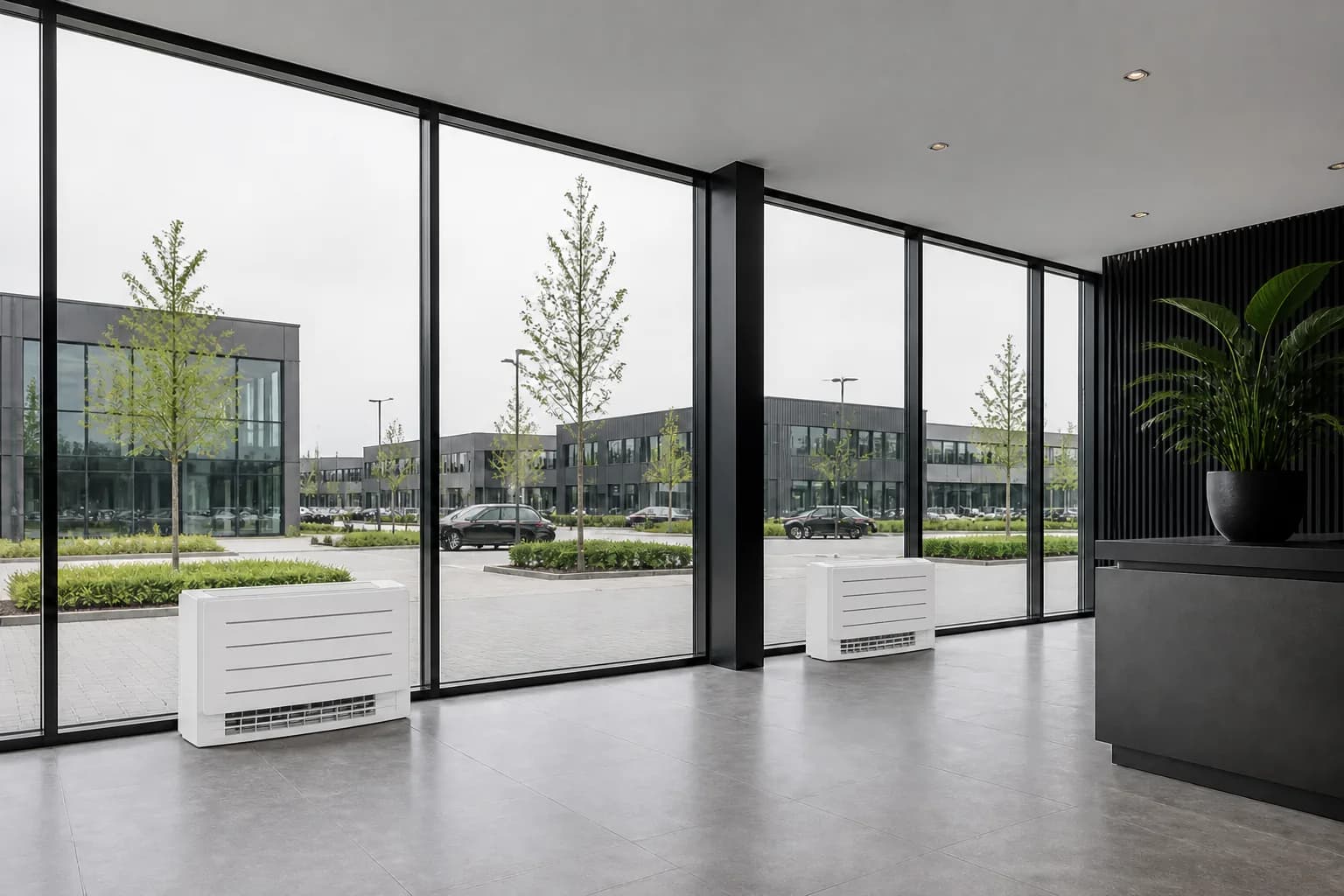 Floor-standing air conditioning units along a glazed facade in a commercial space