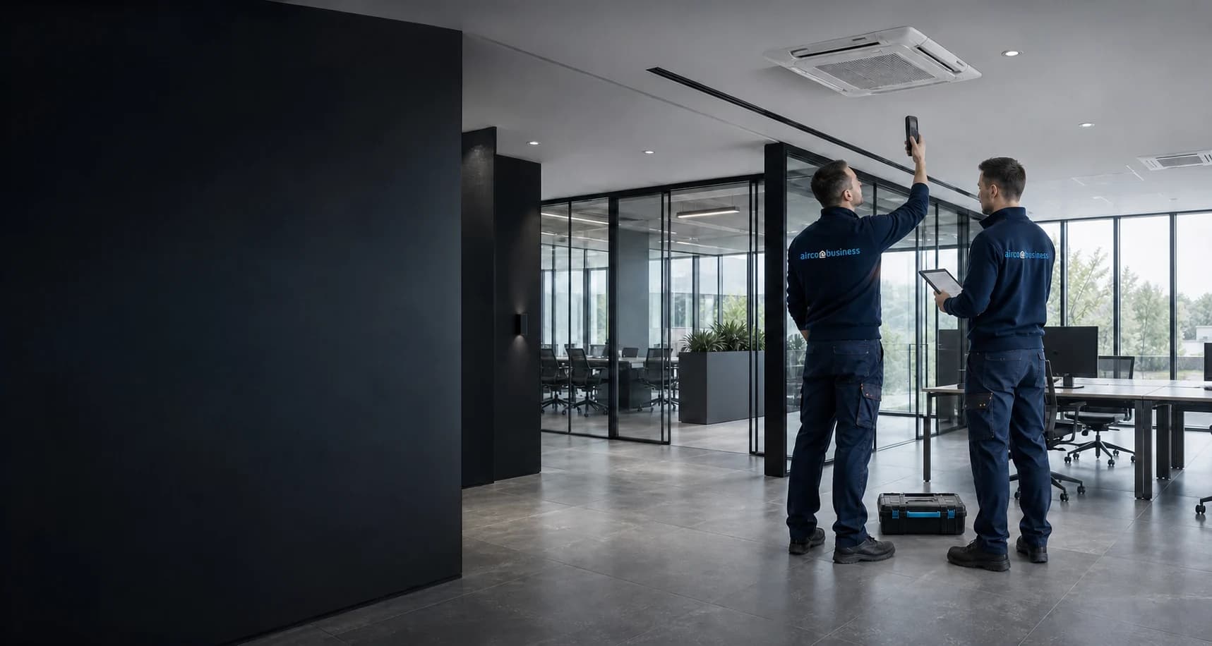 Engineers completing the commissioning of a commercial climate installation in a modern office