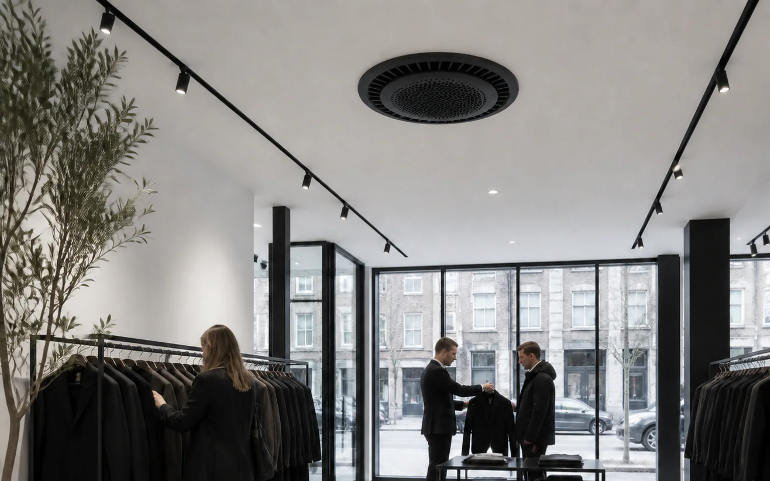 Customers receiving advice in a fashion boutique with a black round 360 degree ceiling cassette